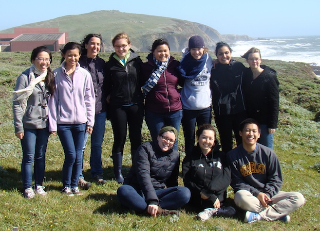 A group of people smiling on a coastline at Bodega Bay