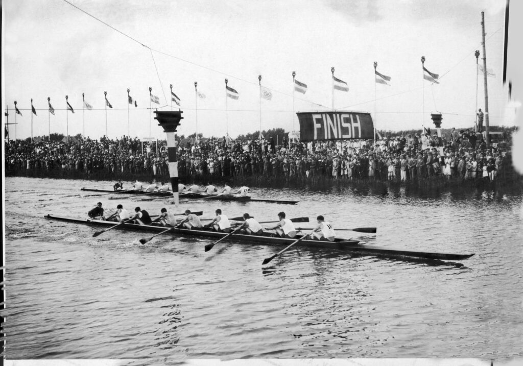 Black and white photo of men rowing